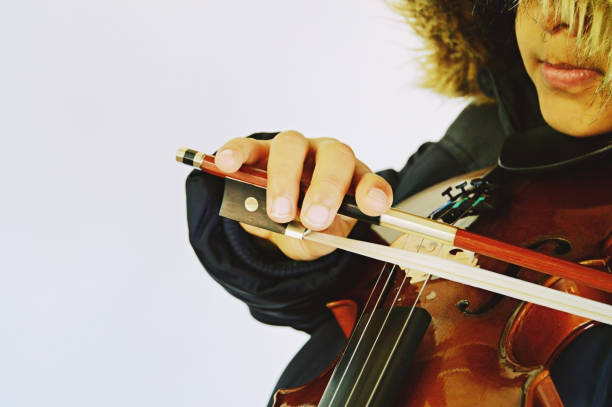 istock A boy playing the stringed and bowed musical instrument, the violin 1094565226