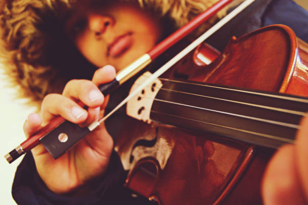 istock A boy playing the stringed and bowed musical instrument, the violin 1094565228
