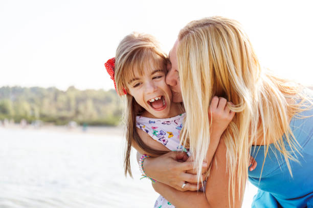istock Mother and daughter having fun on the beach 1094571148