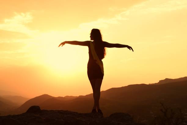 istock Silhouette Woman Standing On Mountain Against Sky During Sunset 1094572104