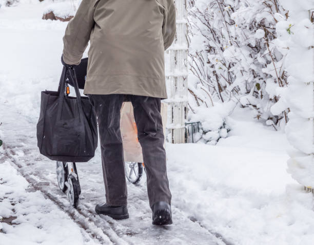 istock Pensioner in winter with a rollator 1094574114