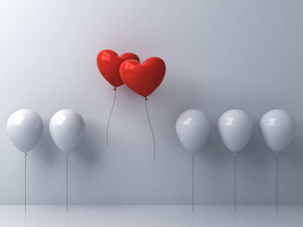 istock Stand out from the crowd and different creative idea Two red heart shape balloons flying away together from white balloons on white wall background Love couple concept for valentine's day 3D rendering 1094574168