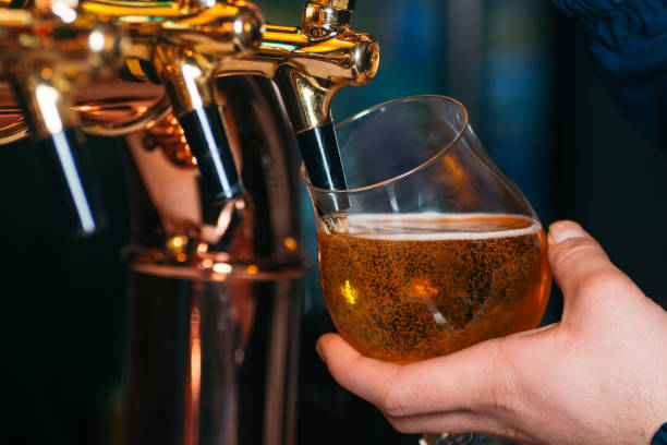 istock Hand of bartender pouring a lager beer in tap 1094576076