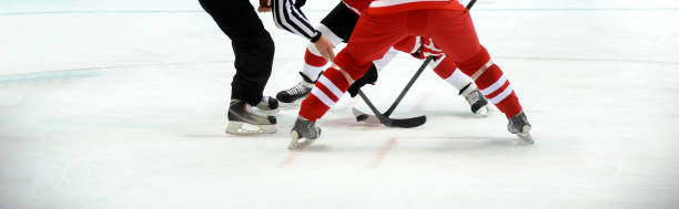 istock Low Section Of Players Playing Ice Hockey 1094578080
