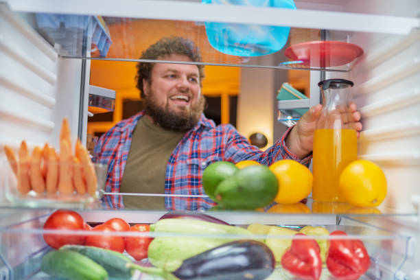istock Man looking for something to eat at night. 1094582260
