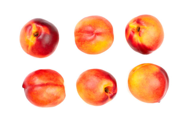 istock ripe nectarine with leaves isolated on white background. Top view. Flat lay pattern. Set or collection 1094584010