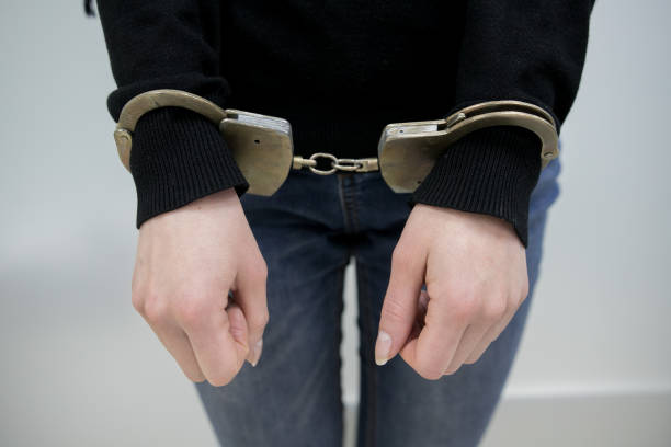 istock imprisoned man with handcuffs on his hands 1094584306