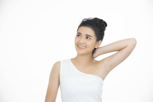 istock Smiling Young Woman Looking Away While Standing Against White Background 1094586656
