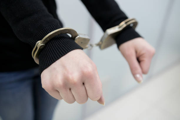istock imprisoned man with handcuffs on his hands 1094589740