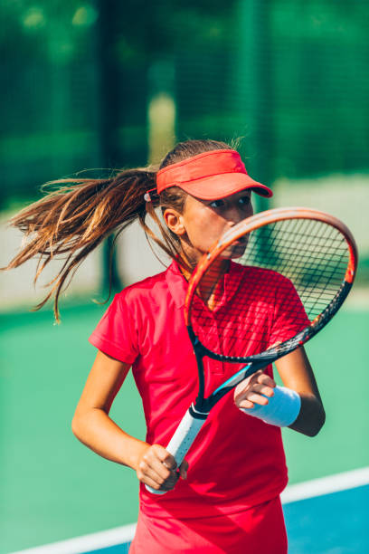 istock Girl Practicing Tennis While Standing In Court 1094593292