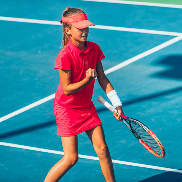 istock Girl Practicing Tennis While Standing In Court During Sunny Day 1094593306