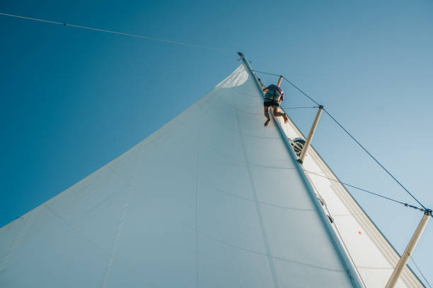 Sailor repairing on sail