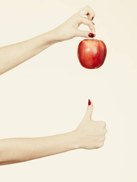 istock Woman hand holding delicious red apple 1094598348