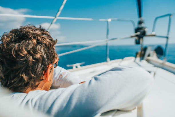 Man looking through a porthole on boat