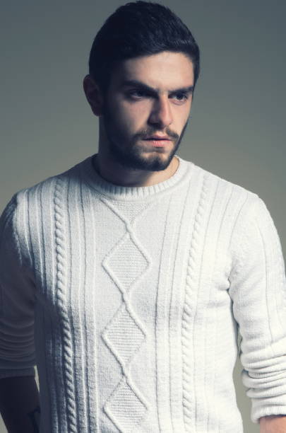 istock Thoughtful Young Man Standing Against Gray Background 1094598790