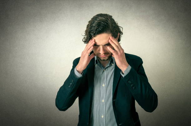 istock Young Businessman Suffering From Headache Standing Against Gray Background 1094601508