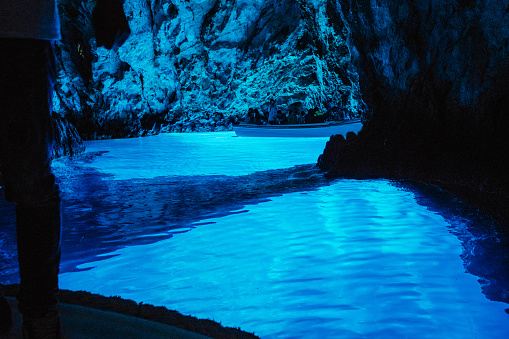 People visiting spectacular blue cave in boat, Modra Spilja, Bisevo, Croatia