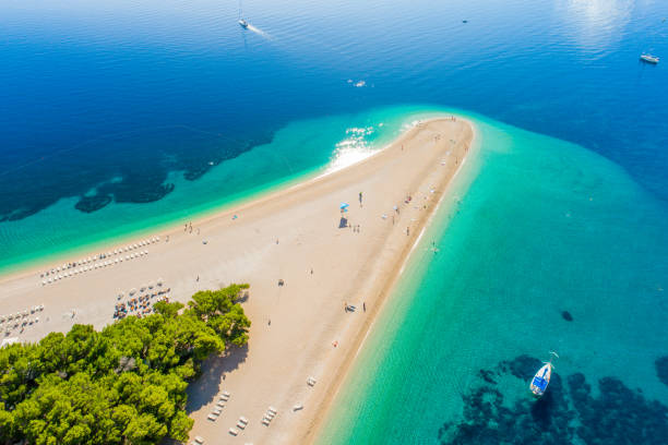 Aerial view of beach on peninsula in Croatia, Bol, Zlatni rat Aerial view of beach on peninsula in Croatia dalmatia region croatia photos stock pictures, royalty-free photos & images