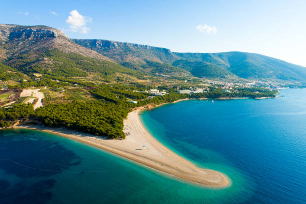 View of coastline with peninsula and town in Croatia, Bol town, Zlatni rat View of coastline with peninsula and town in Croatia brac island stock pictures, royalty-free photos & images