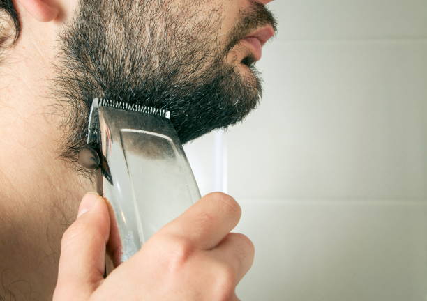 istock Close-Up Of Man Trimming Beard In Bathroom 1094604604