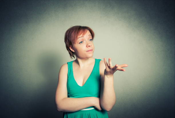 istock Angry Woman Gesturing While Standing Against Gray Background 1094604668