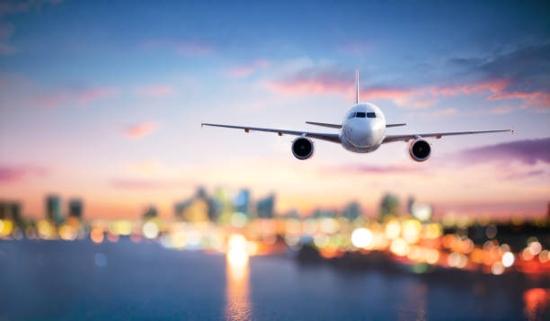 istock Airplane In Flight At Twilight With Blurred Cityscape 1094605308