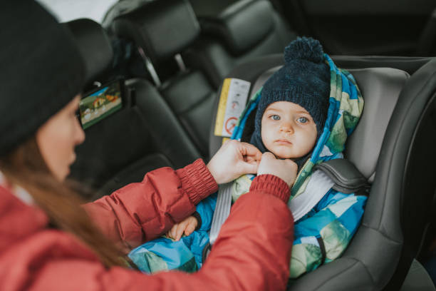 a young married couple with a child cares about safe driving stock photo