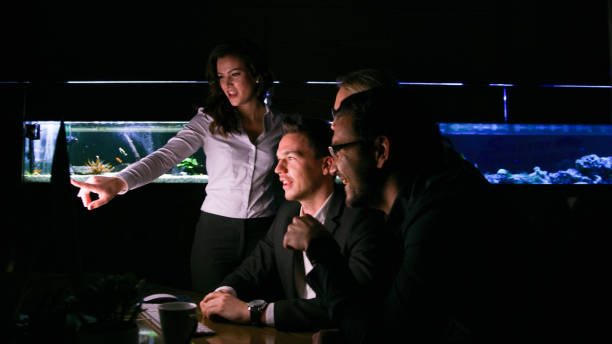 Four business people brainstorming in office