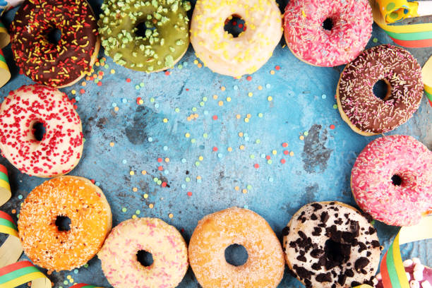 istock assorted donuts with chocolate frosted, pink glazed and sprinkles donuts 1094614260