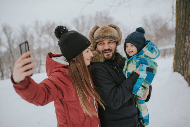 istock Family taking selfie on winter day in the forest 1094614328