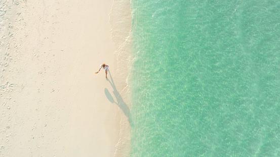 Aerial view of picturesque seascape with walking woman,Maldives