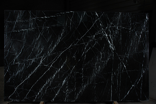 Natural stone is black marble with an interesting pattern called Nero Marquina.