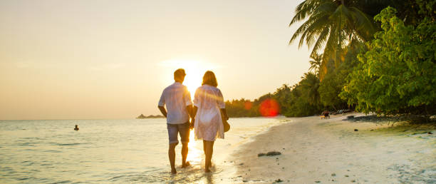 istock View of pair walking in water,Maldives 1094618134
