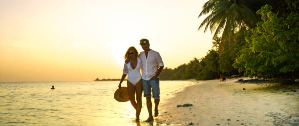 istock View of pair walking in water,Maldives 1094618174