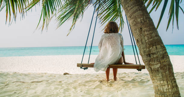 istock Woman on swing on beach,Maldives 1094618218