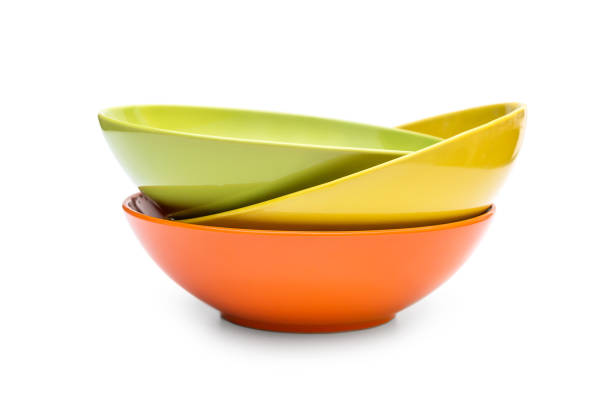 Stack of colorful bowls on white. stock photo