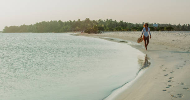 istock Woman walking on beach,Maldives 1094618278