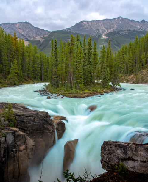 istock Sunwapta Falls with blue water flowing in Spring, Alberta, Canada. 1094618512