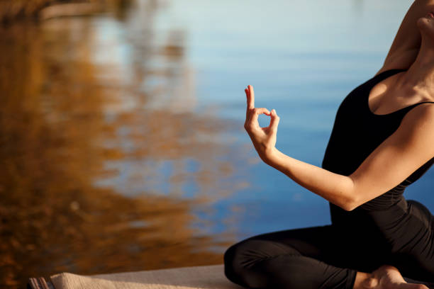 istock Young girl practicing yoga exercise at quiet pier in autumn park. 1094620856