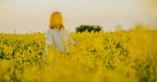 istock View of woman sitting on field 1094621562
