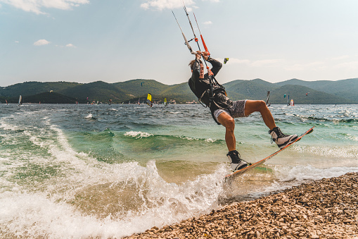 Portrait of windsurfer jumping next to seashore,Peljesac