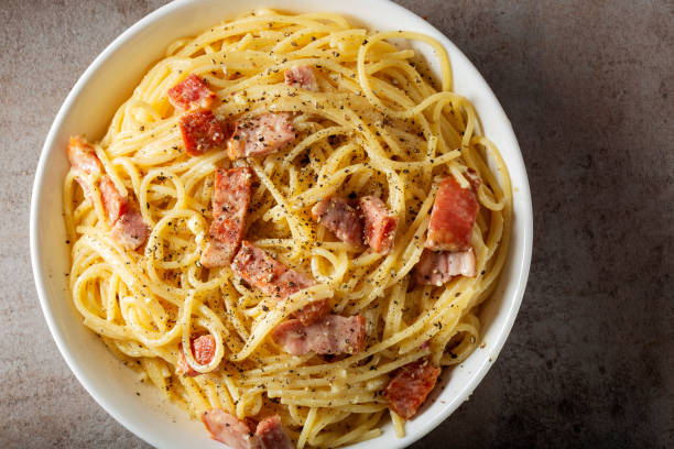 istock Spaghetti carbonara with pancetta, eggs and cheese in white bowl 1094624206