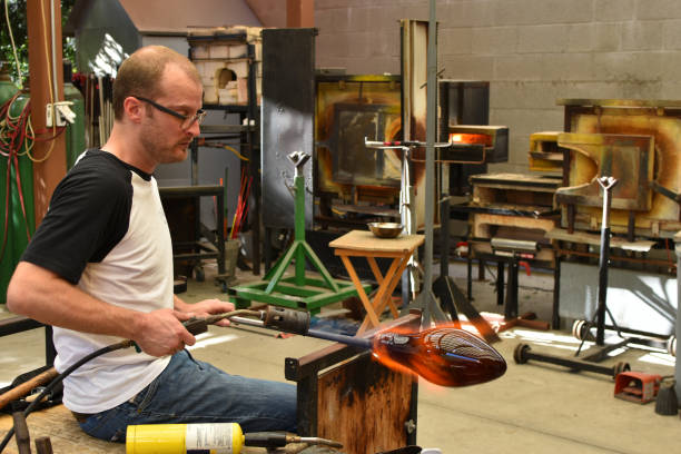 istock Glassblower heating glass with a torch 1094625926