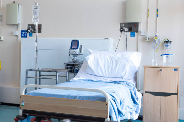 Empty bed in a hospital ward stock photo