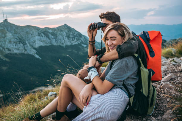 istock beautiful young couple relaxing after hiking and taking a break 1094626756