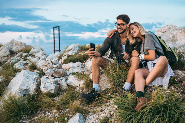 istock beautiful young couple relaxing after hiking and taking a break 1094626806