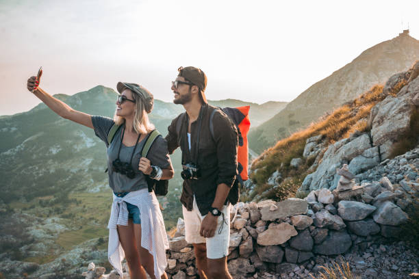 istock young couple hiking and taking a selfie 1094628456