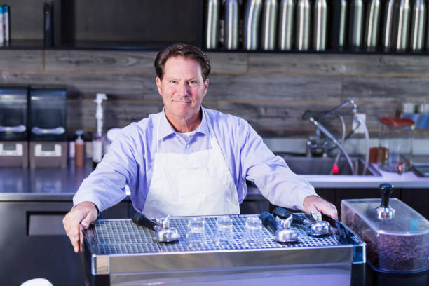 istock Mature man working in coffee shop 1094629644