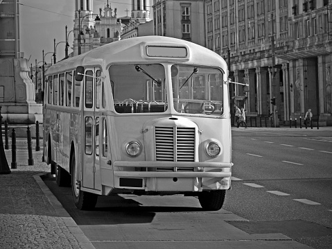 Old nostalgic bus parked on the street. Black and white photo.