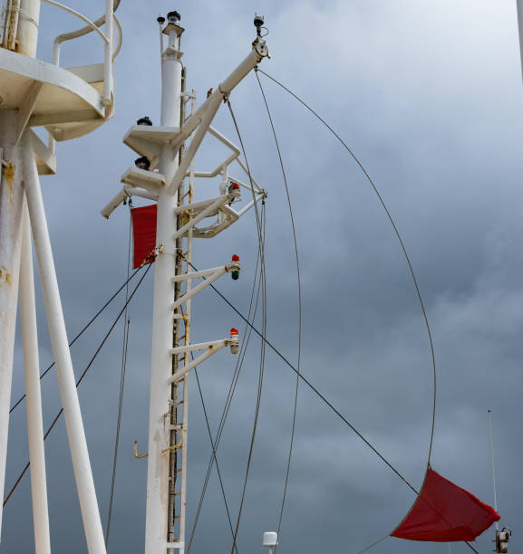 istock hoist red flag on top a merchant vessel 1094634524